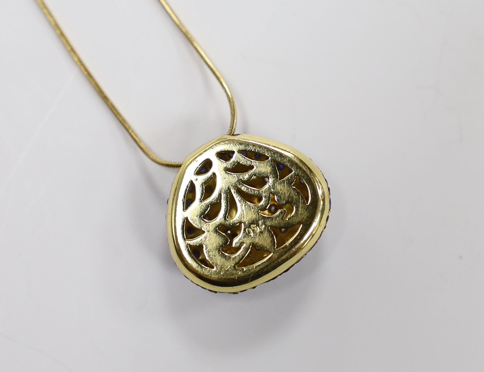 A modern 750 yellow metal, sapphire and diamond cluster set pendant necklace, overall 44cm, gross weight 9.3 grams.
